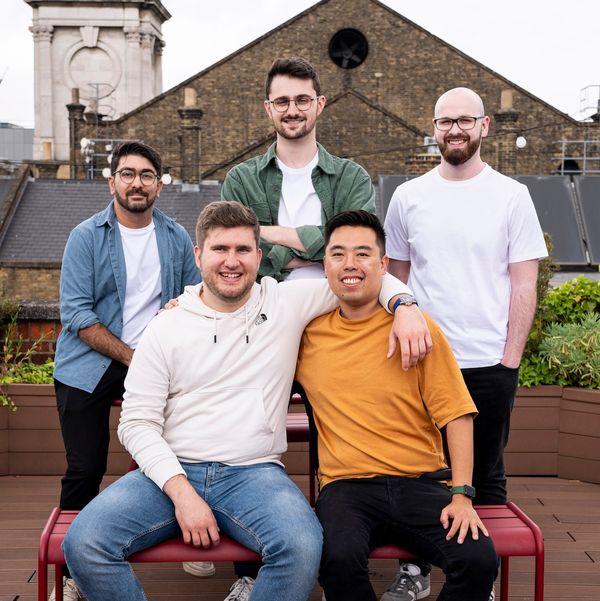 Pandelis Zembashis, Sam Stenner, John Ingram stand behind a seated Alistair Pullen and Yang Li